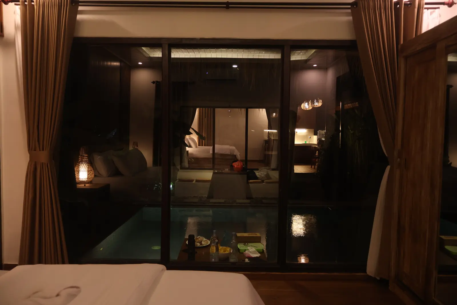 Second bedroom looking across the pool in the evening