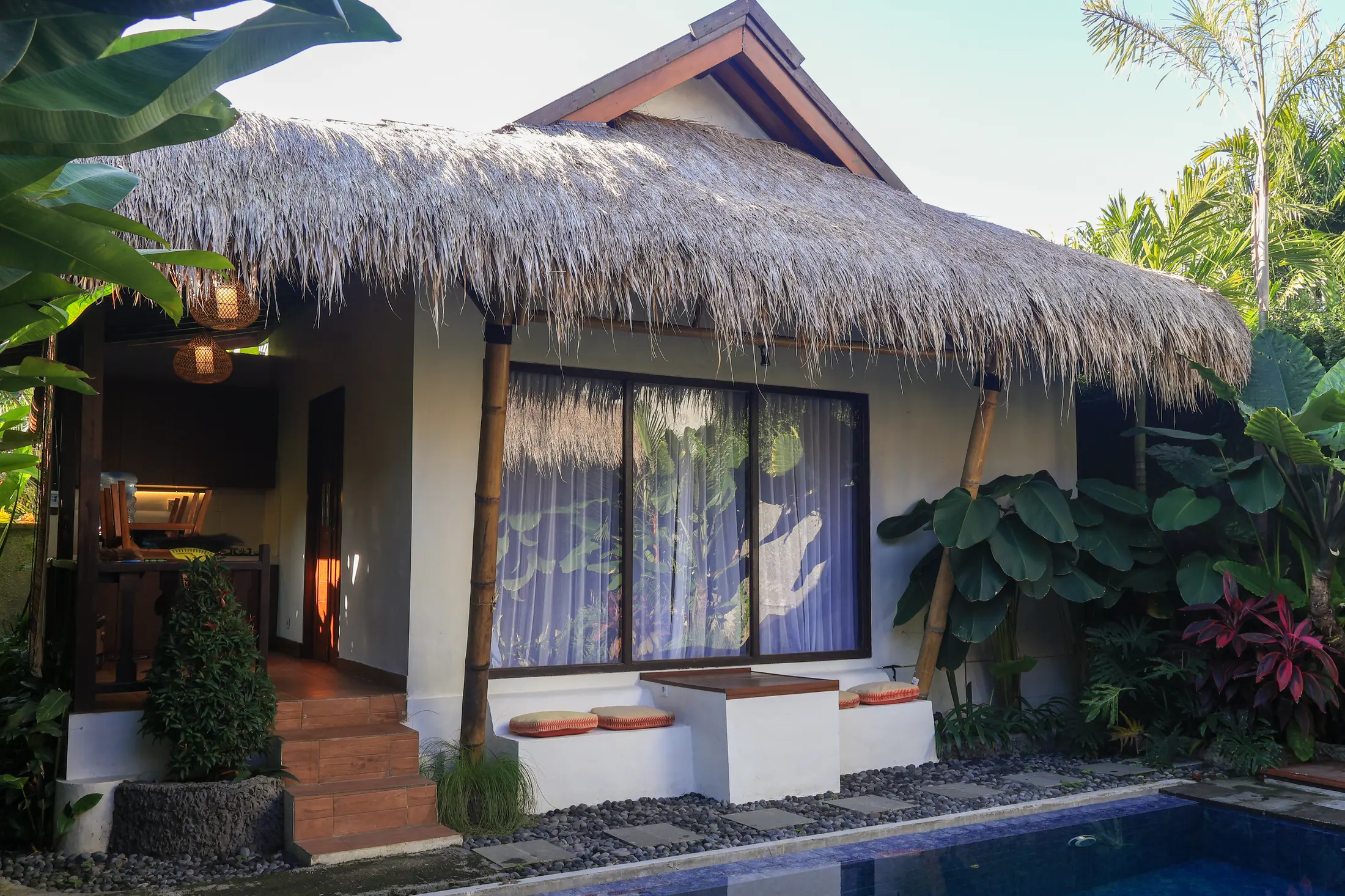 Daytime view of the villa beside its pool